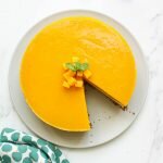 mango cheesecake from above with one piece cut out